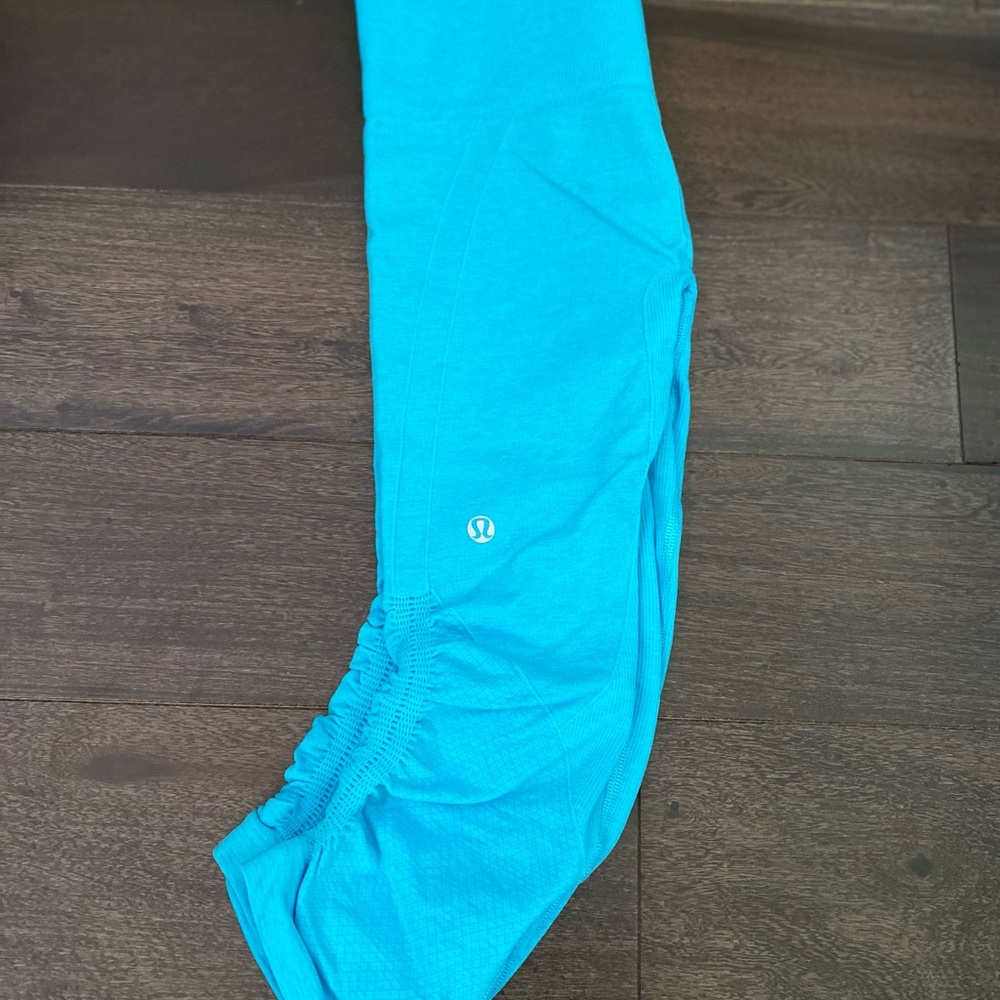 2 pairs of Lululemon workout pants, one bright blue, one black